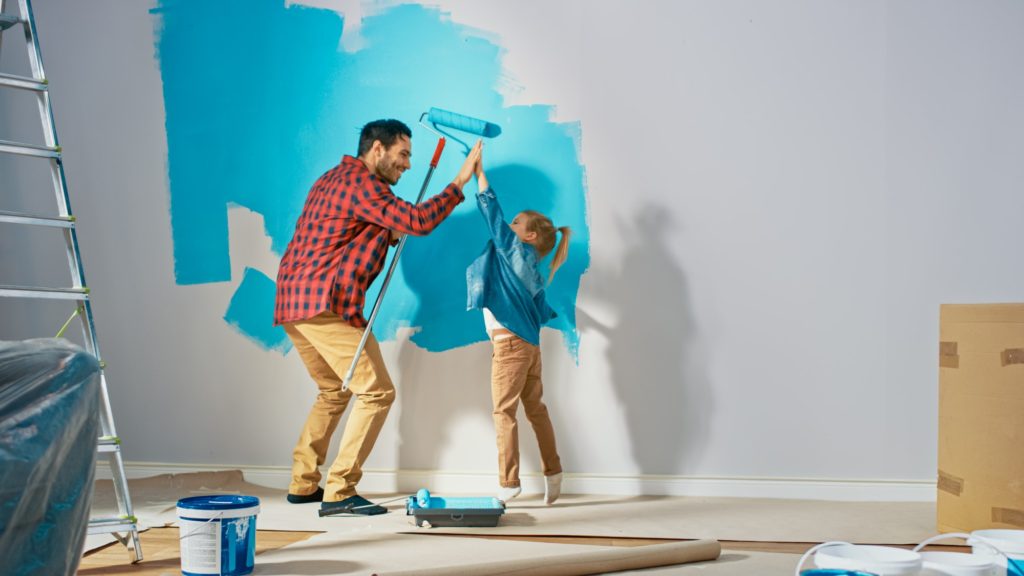 father and daughter painting a room blue for a refreshing summer vibe