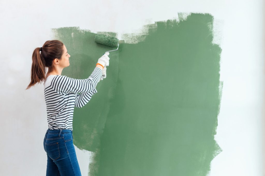 woman painting her home interior